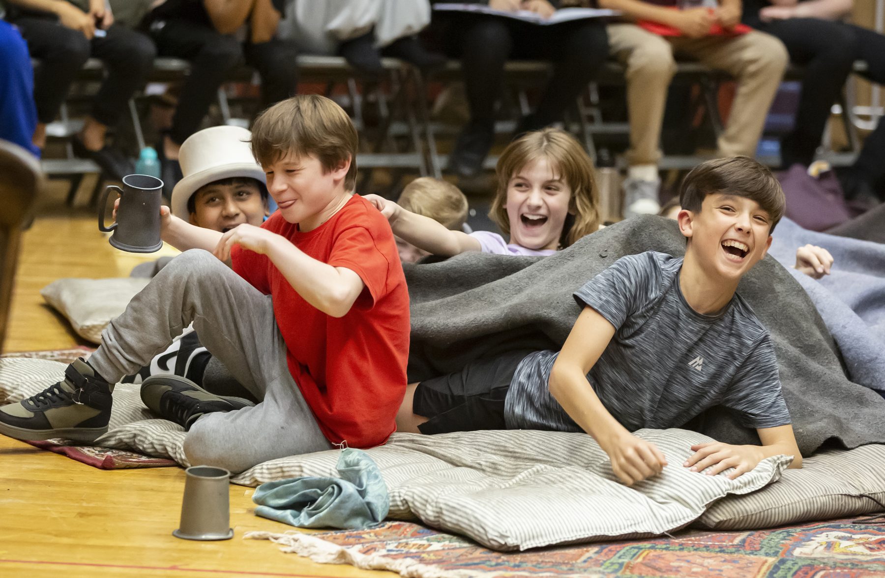 Theo Wake (Oliver Twist) with young comany members in Oliver! rehearsals. Photo by Pamela Raith